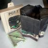 POT-T Unit with a liner, alongside its cardboard shipper and a pack of one dozen liner bags. All of these items are placed on a white table.